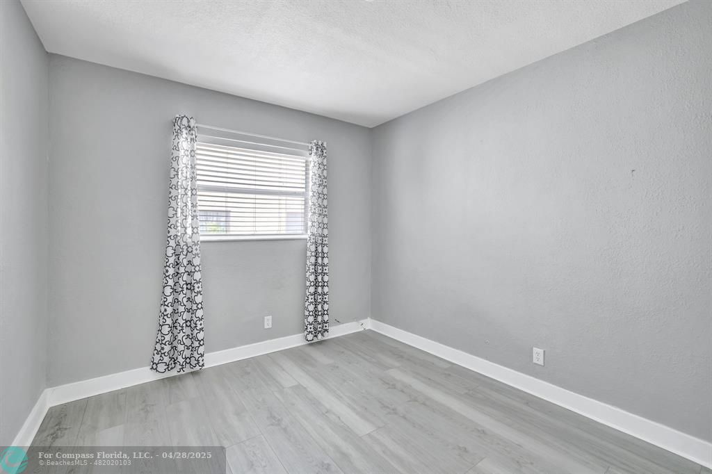 2741 Northeast 8th Avenue, Unit 15 Wilton Manors, FL 33334 - Photo 16 of 46 an empty room with windows