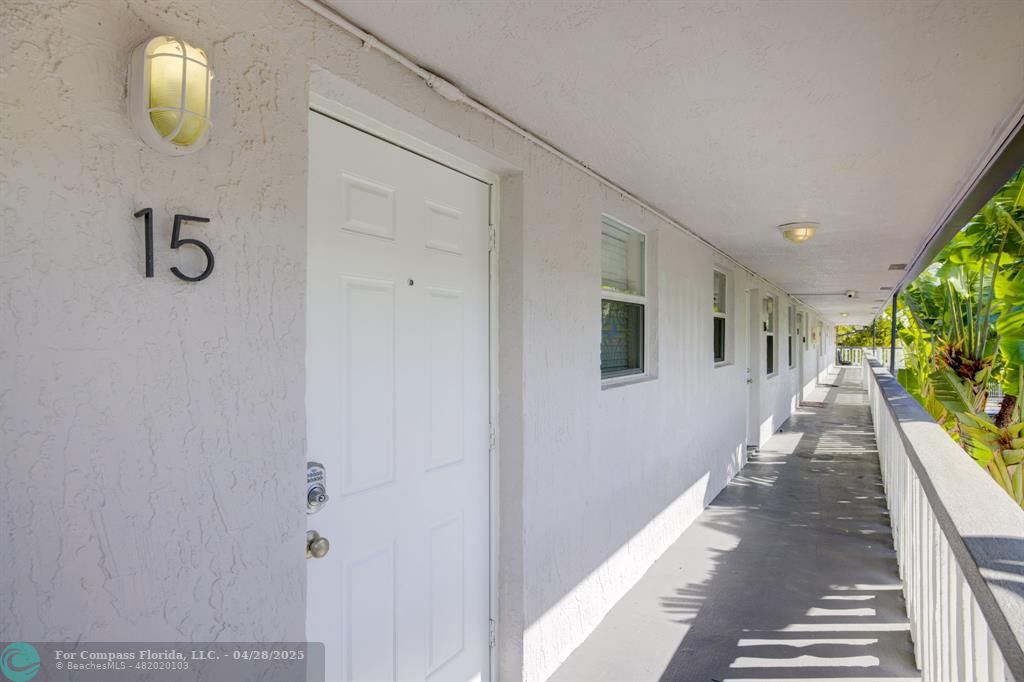 2741 Northeast 8th Avenue, Unit 15 Wilton Manors, FL 33334 - Photo 17 of 46 a view of a hallway to a window
