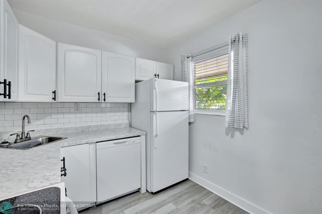 2741 Northeast 8th Avenue, Unit 15 Wilton Manors, FL 33334 - Photo 2 of 46 a white refrigerator freezer sitting inside of a kitchen