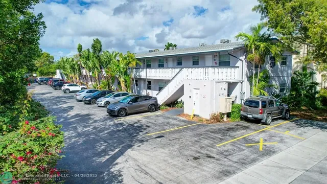 a view of a house with a yard and sitting area