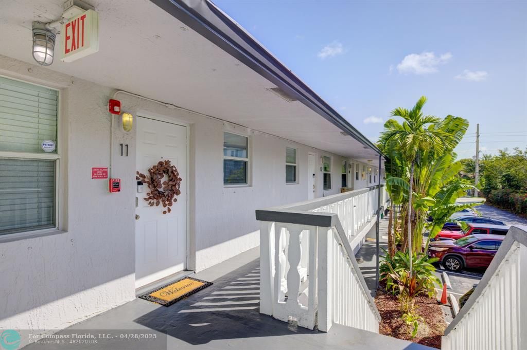 2741 Northeast 8th Avenue, Unit 15 Wilton Manors, FL 33334 - Photo 23 of 46 a view of an entryway with wooden floor