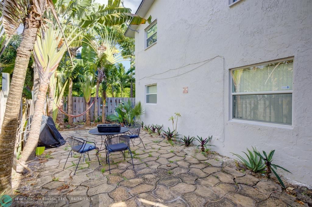 2741 Northeast 8th Avenue, Unit 15 Wilton Manors, FL 33334 - Photo 29 of 46 a view of a chair and table in backyard of the house