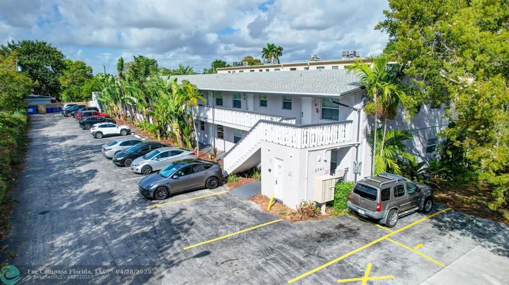 2741 Northeast 8th Avenue, Unit 15 Wilton Manors, FL 33334 - Photo 32 of 46 a front view of a house with garden