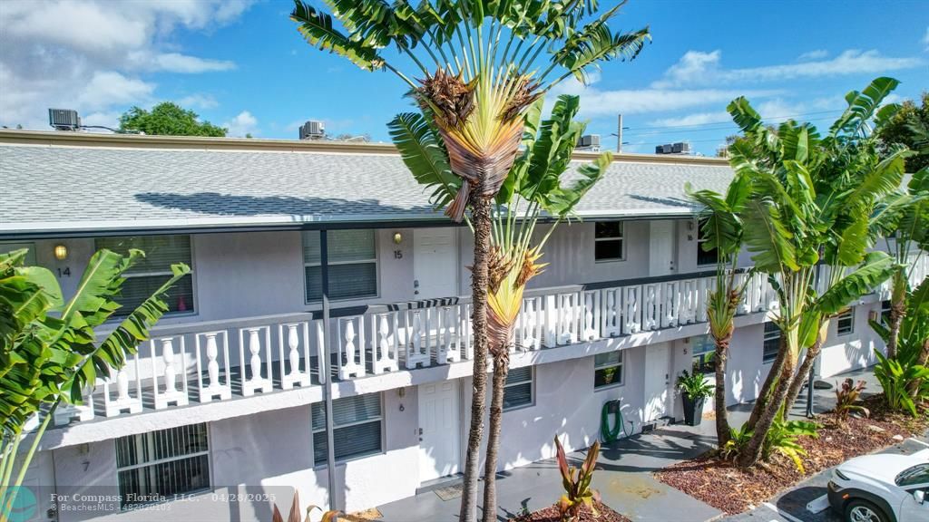 2741 Northeast 8th Avenue, Unit 15 Wilton Manors, FL 33334 - Photo 33 of 46 a front view of a house with a tree