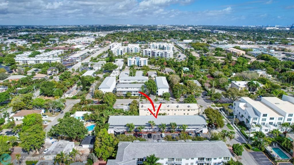 2741 Northeast 8th Avenue, Unit 15 Wilton Manors, FL 33334 - Photo 44 of 46 an aerial view of residential building and car parked