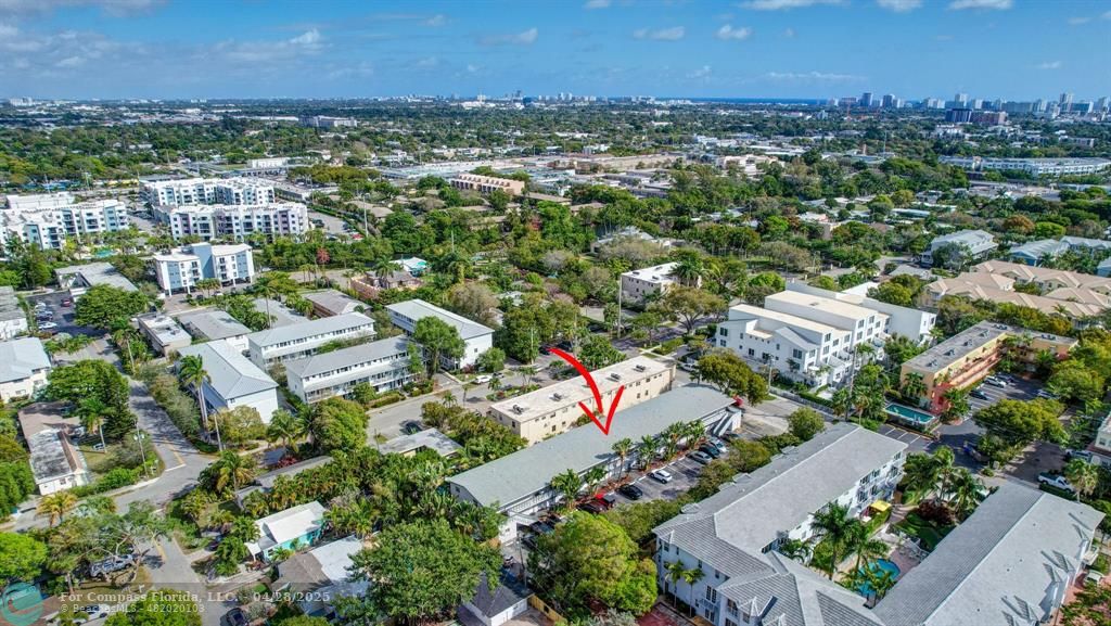 2741 Northeast 8th Avenue, Unit 15 Wilton Manors, FL 33334 - Photo 45 of 46 an aerial view of residential houses with outdoor space and trees