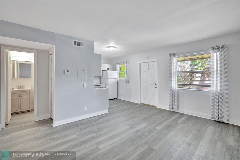 2741 Northeast 8th Avenue, Unit 15 Wilton Manors, FL 33334 - Photo 6 of 46 wooden floor in an empty room with a window