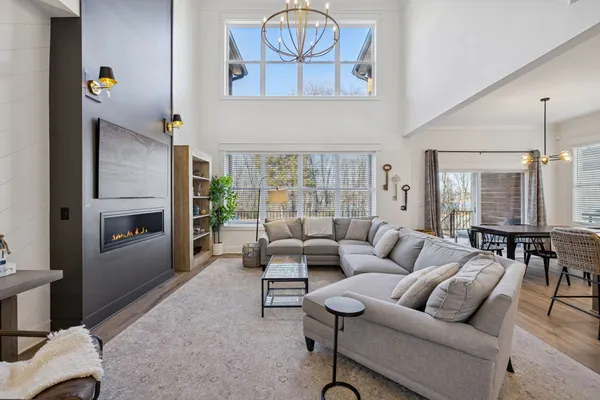 a living room with furniture a rug and a window