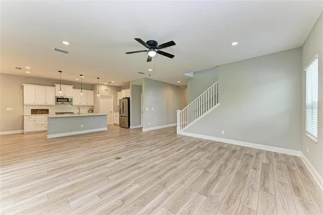 a view of a hallway with wooden floor and entryway