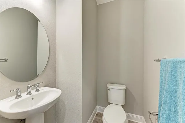 a view of an empty room with a window and a kitchen