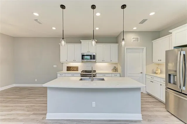 an empty room with a window and ceiling fan