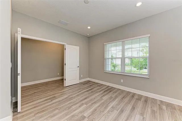 a kitchen with kitchen island a sink a stove a refrigerator and white cabinets