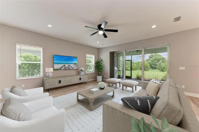 a kitchen with a stove a sink a refrigerator and white cabinets with wooden floor