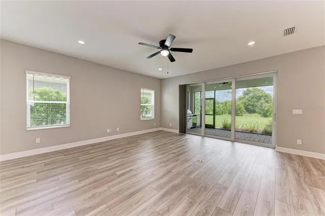 a kitchen with a sink stove and wooden floor