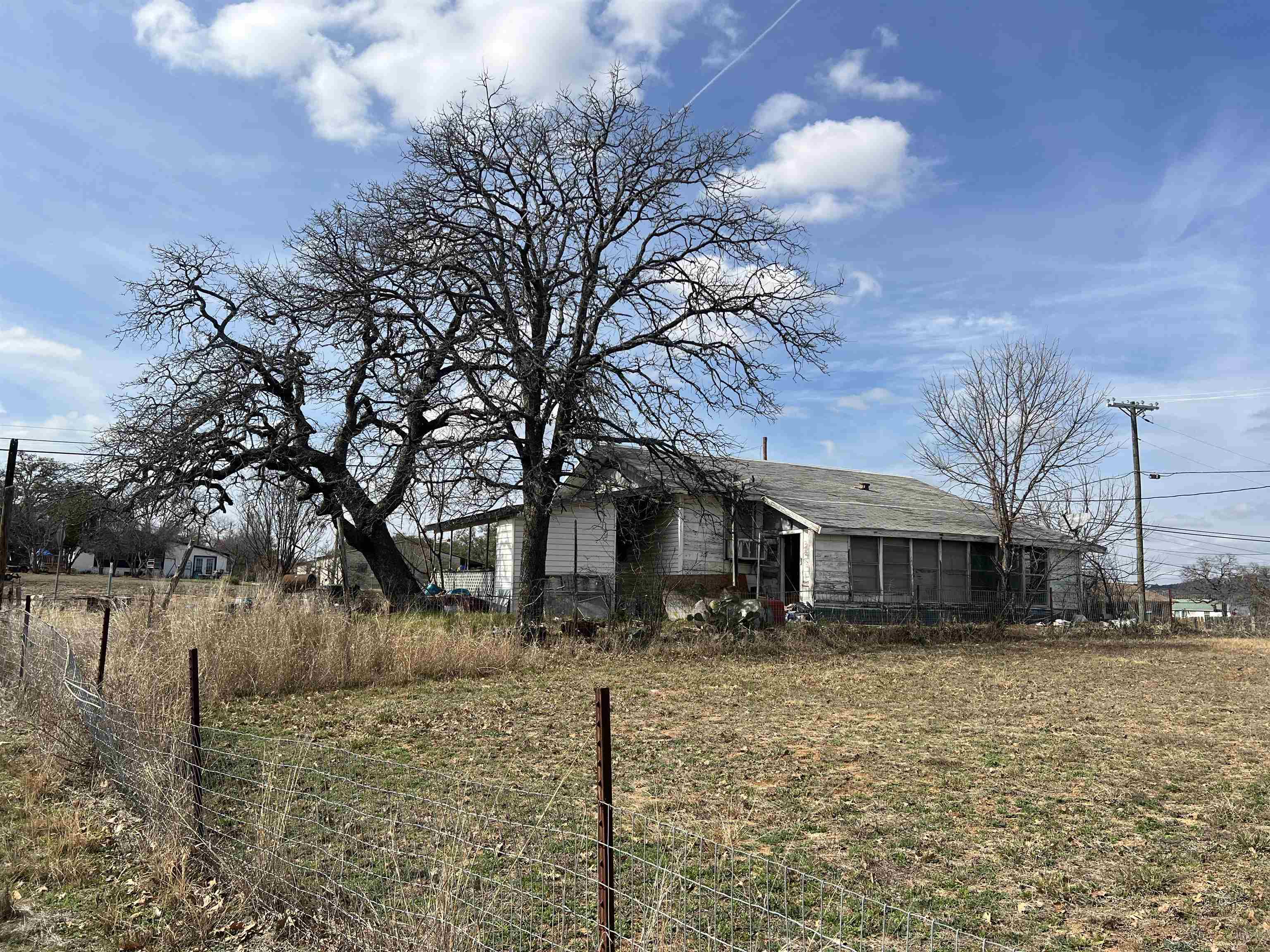 1034 Ranch Road 2545 Kingsland, TX 78639 - Photo 4 of 30 a front view of a house with a yard