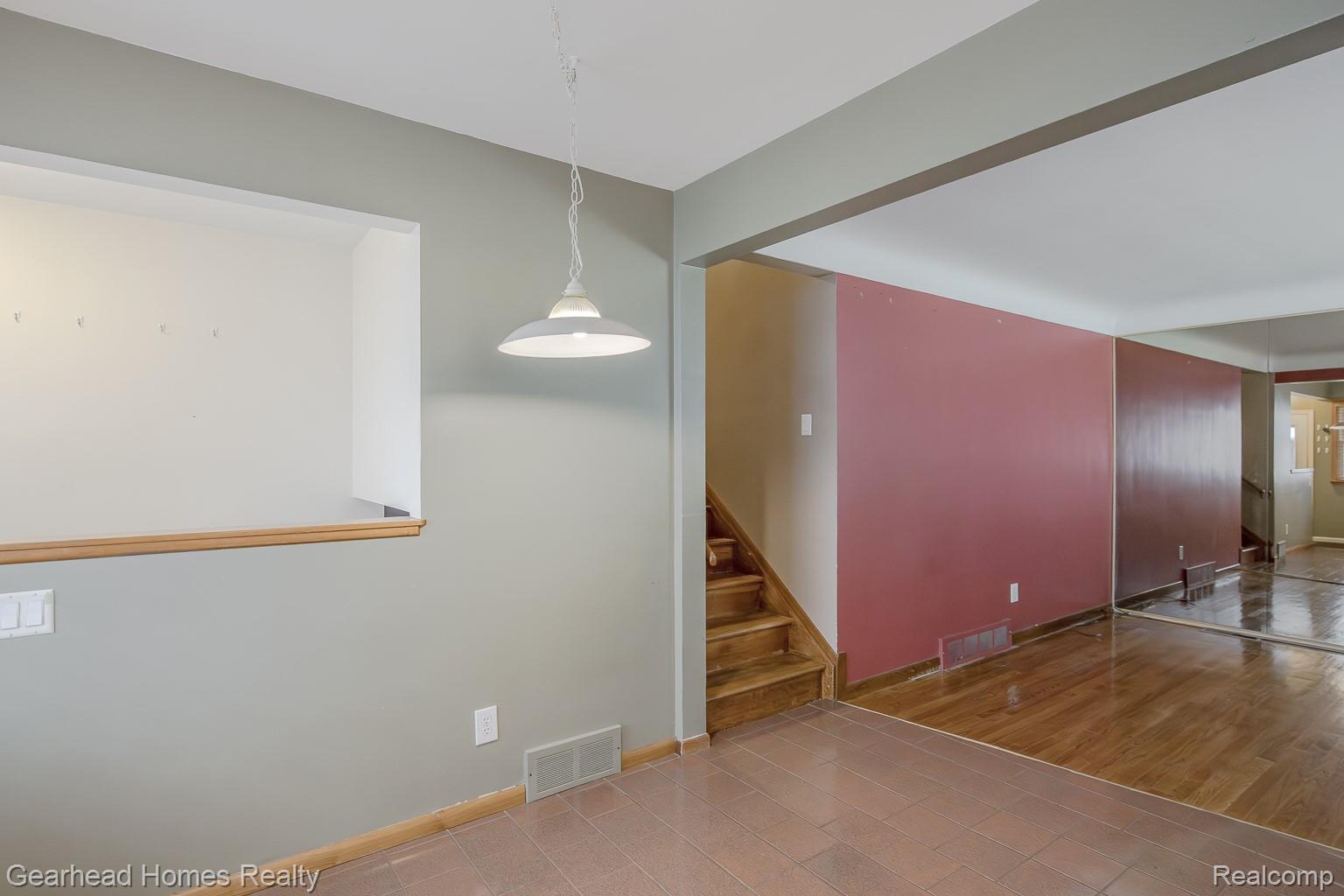3356 Harding Street Dearborn, MI 48124 - Photo 11 of 48 Tile flooring, wood-finish flooring, staircase with wood treads, overhead pendant lighting, wall cut-out feature