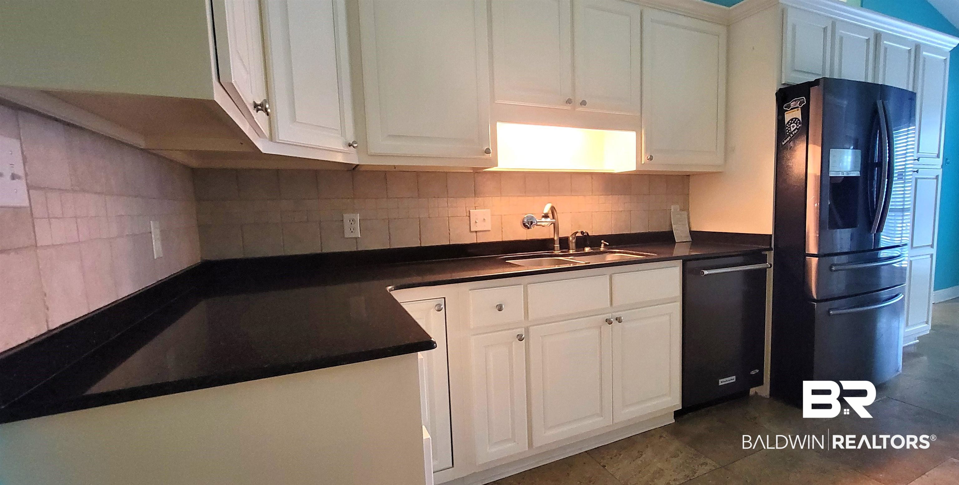 31821 River Road Orange Beach, AL 36561 - Photo 5 of 17 Tons of storage. Pantry and appliance closet.