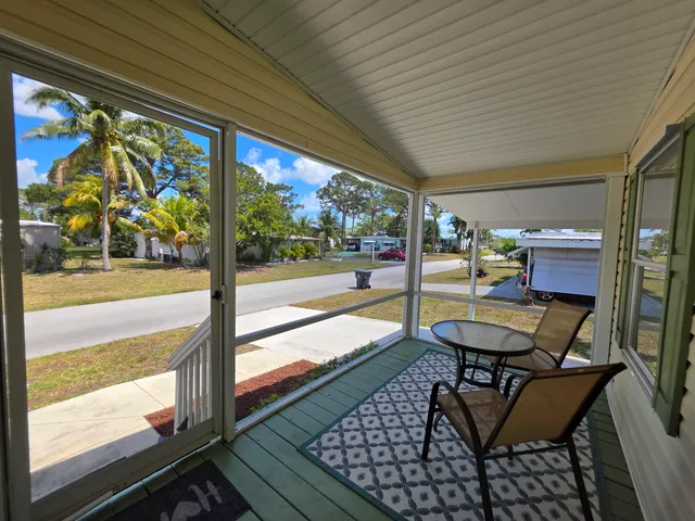 a balcony with chairs and outdoor dining table