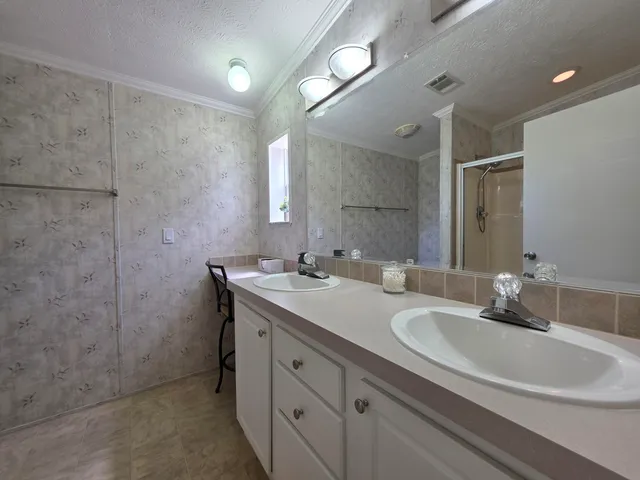 a bathroom with a double vanity sink and a mirror
