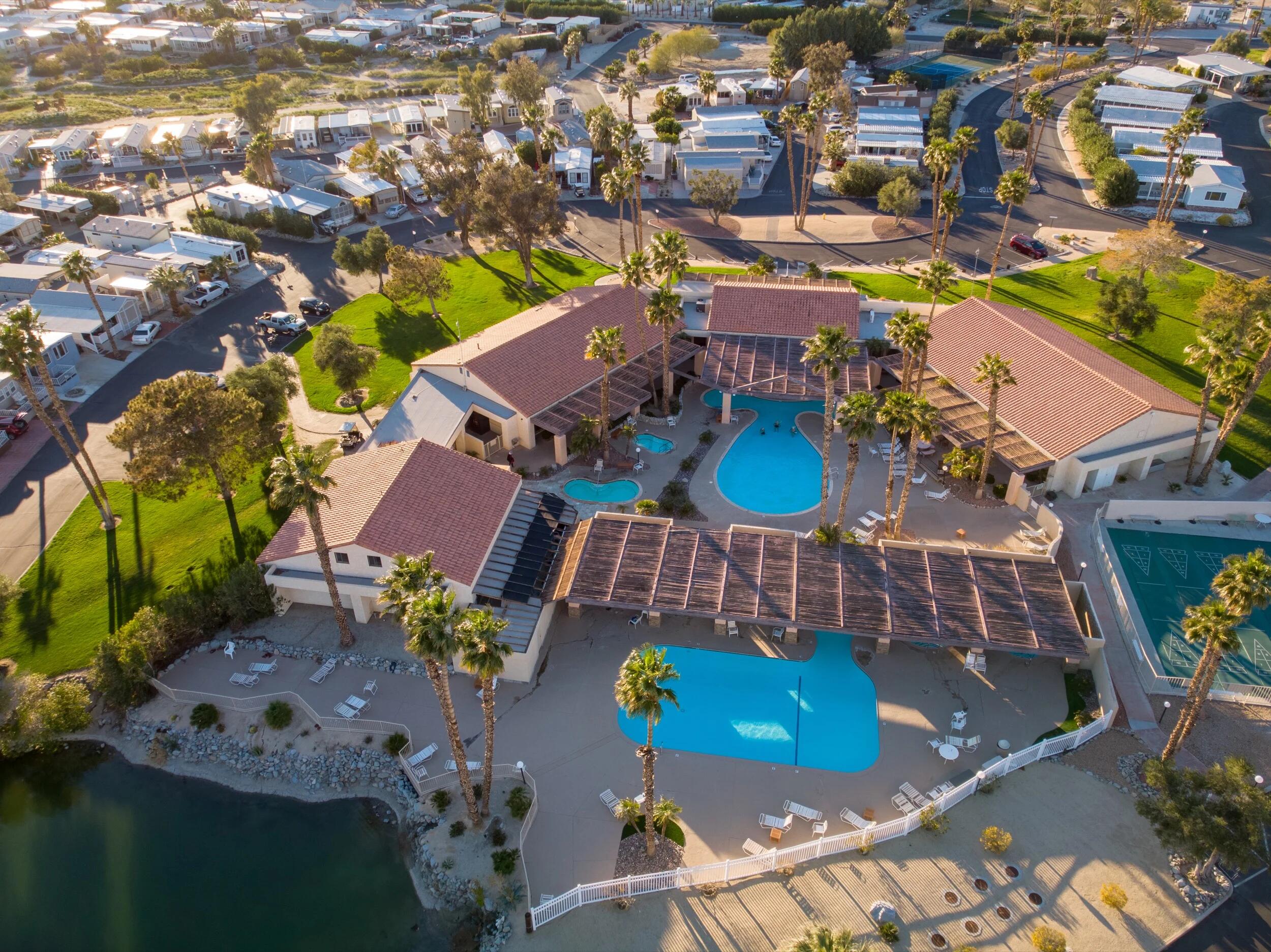 74711 Dillon Road, Unit 392 Desert Hot Springs, CA 92241 - Photo 2 of 46 an aerial view of a house with a swimming pool outdoor seating and yard
