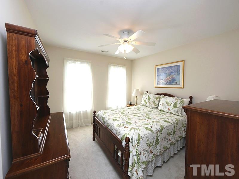 4100 Heathgate Lane Raleigh, NC 27613 - Photo 18 of 25 a bedroom with a bed and a window