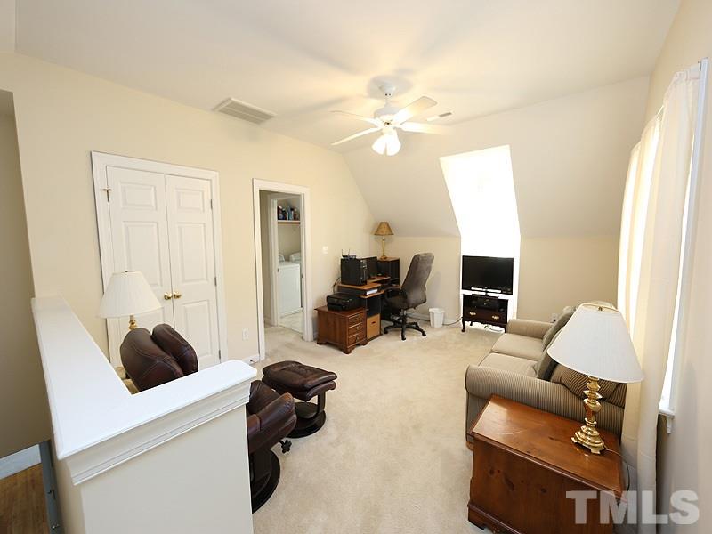 4100 Heathgate Lane Raleigh, NC 27613 - Photo 21 of 25 a living room with furniture and a flat screen tv