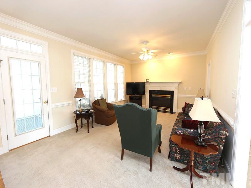 4100 Heathgate Lane Raleigh, NC 27613 - Photo 9 of 25 a living room with furniture a flat screen tv and a window