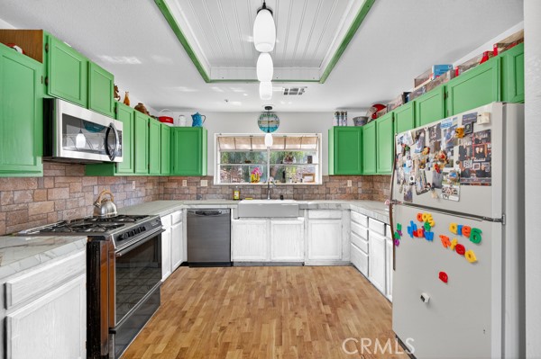 34215 Simla Street Acton, CA 93510 - Photo 14 of 37 a kitchen with a white cabinets stove and refrigerator