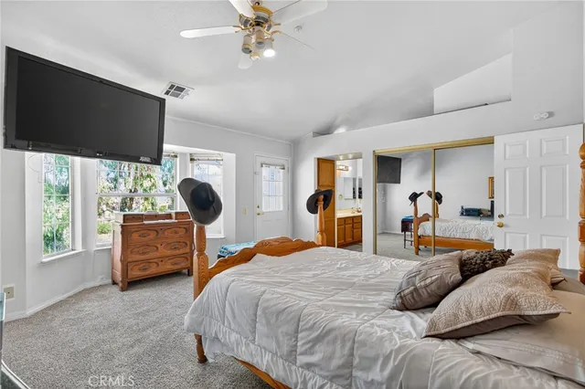 a bedroom with bed and a chandelier