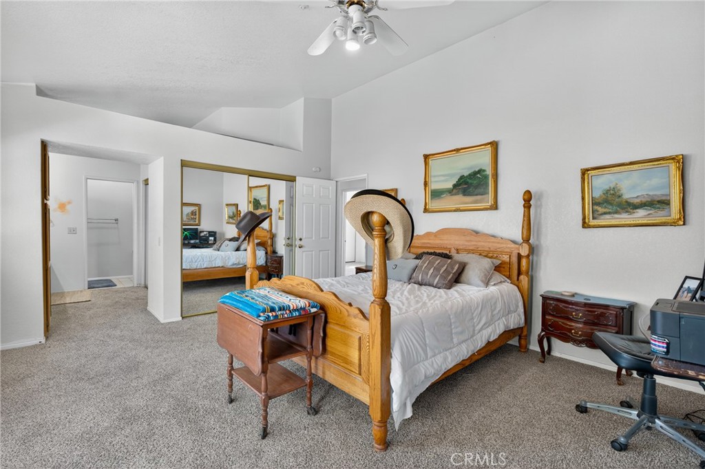 34215 Simla Street Acton, CA 93510 - Photo 19 of 37 a bedroom with bed and a chandelier