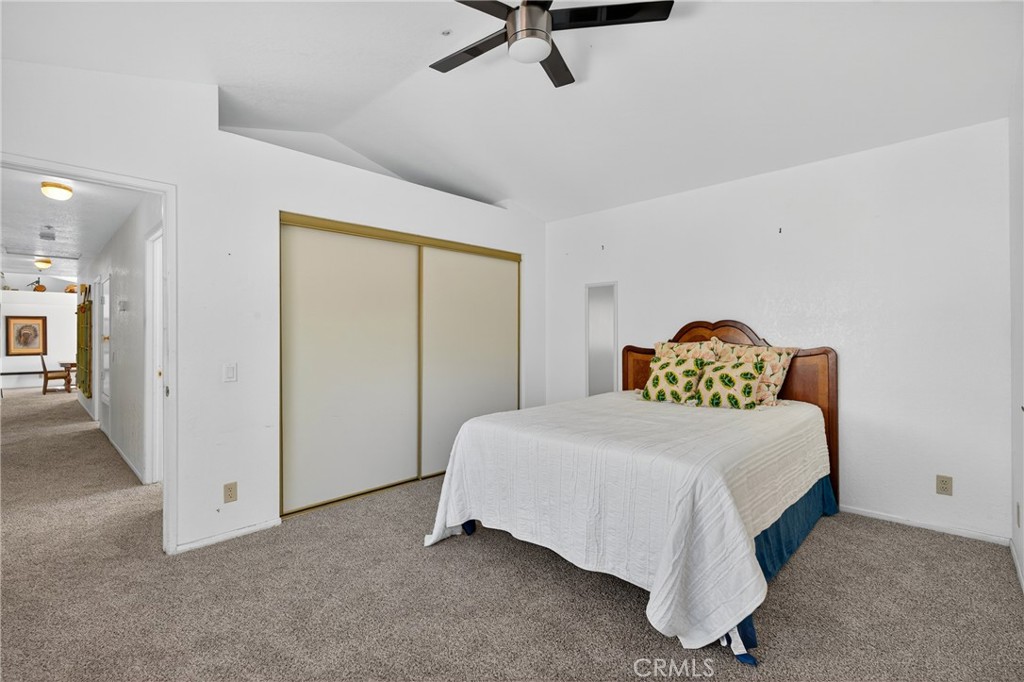 34215 Simla Street Acton, CA 93510 - Photo 27 of 37 a bedroom with a bed and a chandelier
