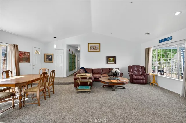 a living room with furniture a fireplace and a large window