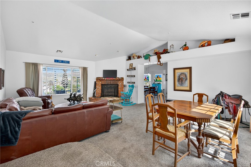34215 Simla Street Acton, CA 93510 - Photo 6 of 37 a living room with furniture a fireplace and a large window