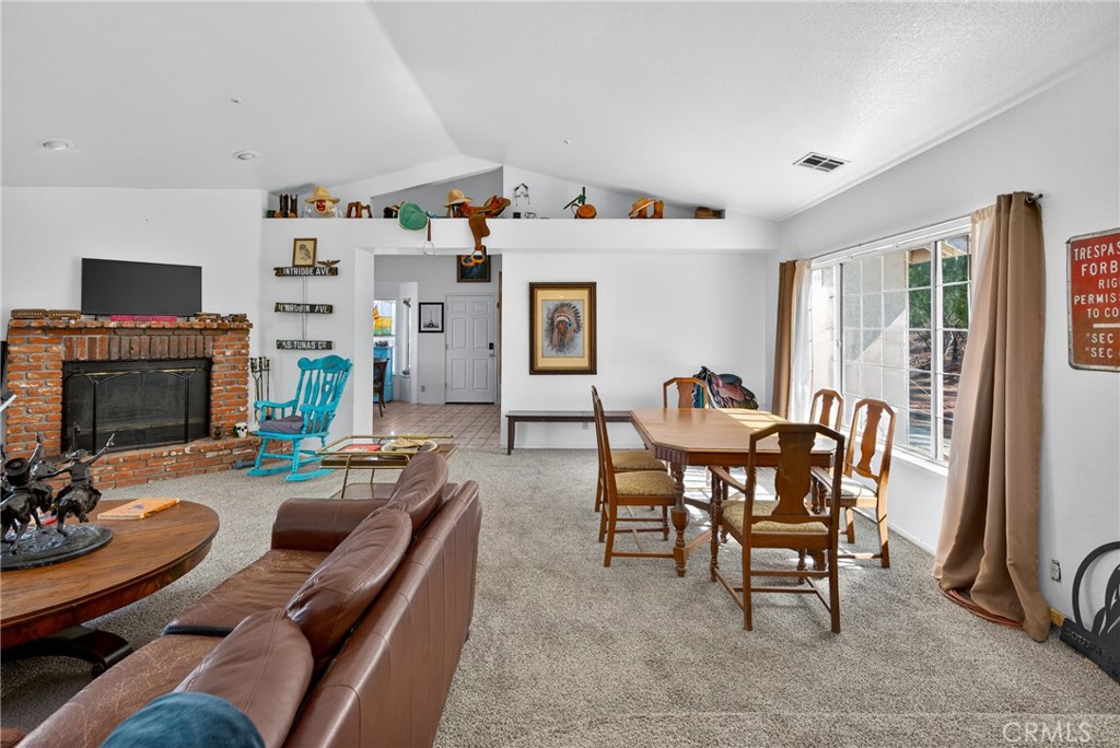34215 Simla Street Acton, CA 93510 - Photo 10 of 37 a living room with furniture a flat screen tv and a fireplace