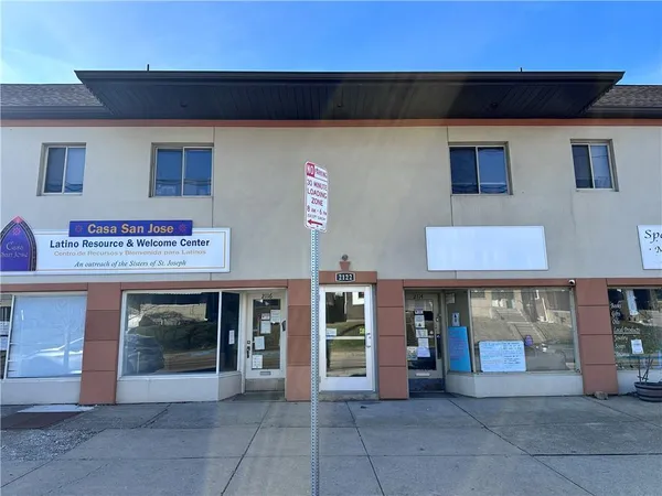 a front view of a building with parking