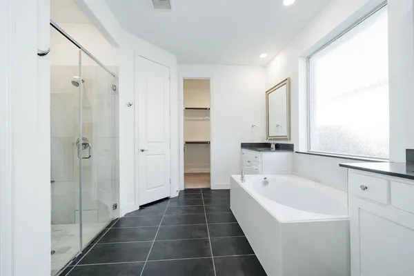 a bathroom with a bathtub and a shower