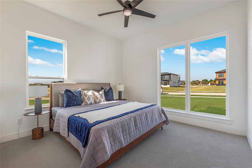 430 Whispering Way Red Oak, TX 75154 - Photo 30 of 40 Bedroom featuring high ceilings, white walls, large windows, and gray carpet flooring