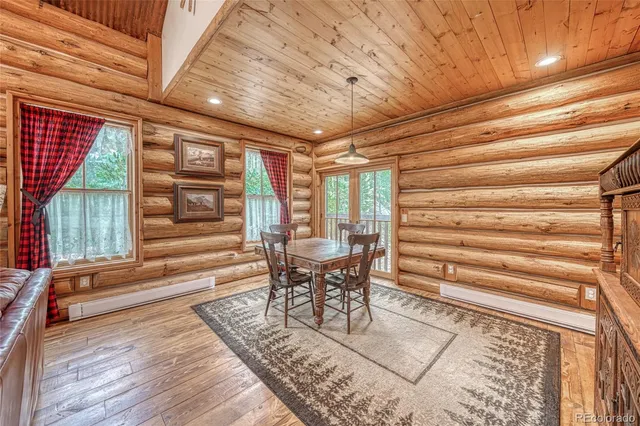 a dining room with furniture and wooden floor