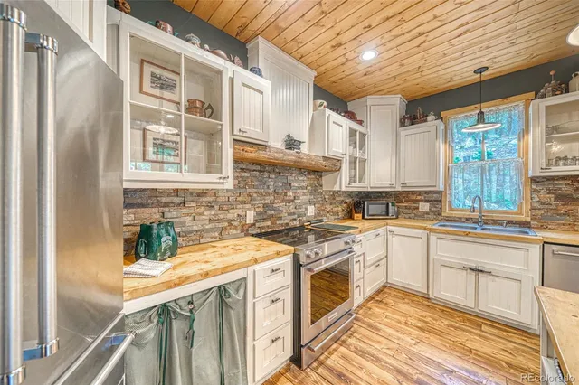 a kitchen with stainless steel appliances granite countertop a stove and a sink