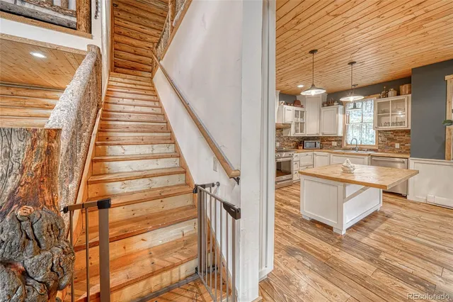 a view of kitchen with wooden floor and electronic appliances