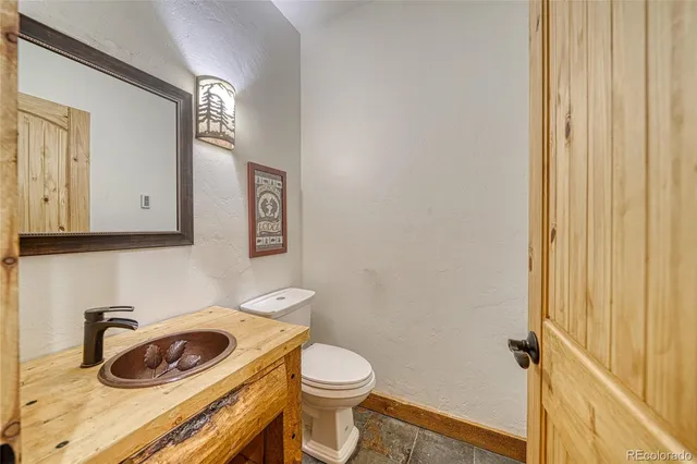 a bathroom with a toilet a sink and vanity