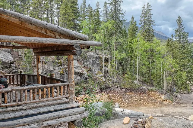 a view of backyard with deck and outdoor seating