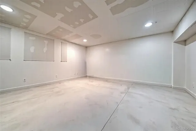 an empty room with a empty space and windows