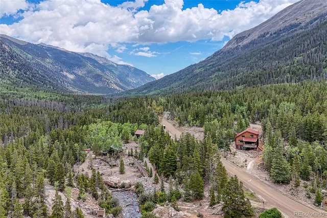 a aerial view of a house with a yard basket ball court and outdoor seating
