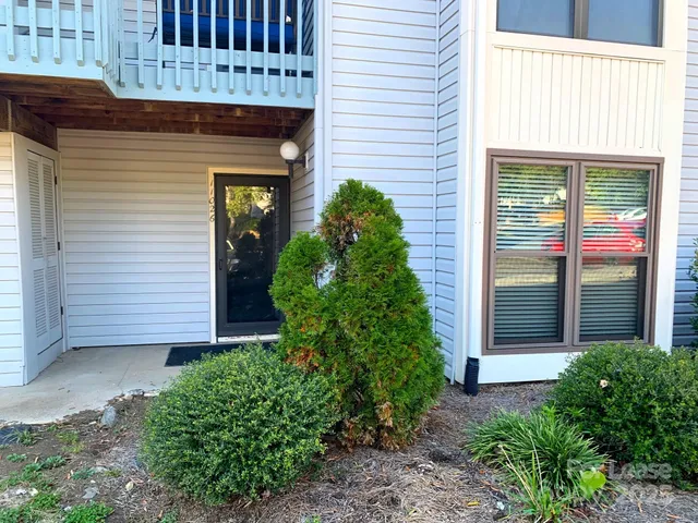 a front view of a house with plants