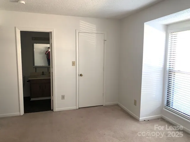 a view of an empty room and a window