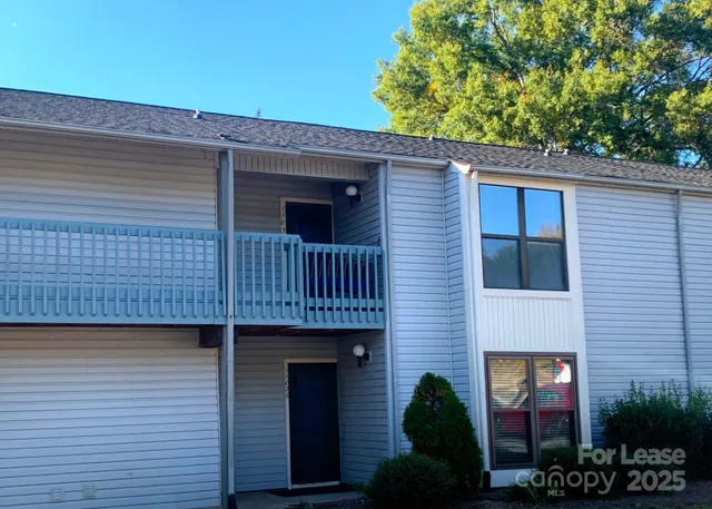 a view of a house with brick walls and potted plants
