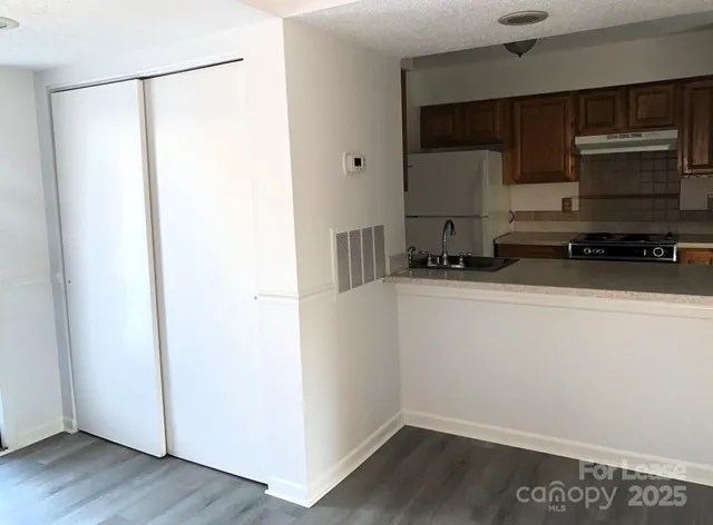 a kitchen with a refrigerator and a sink