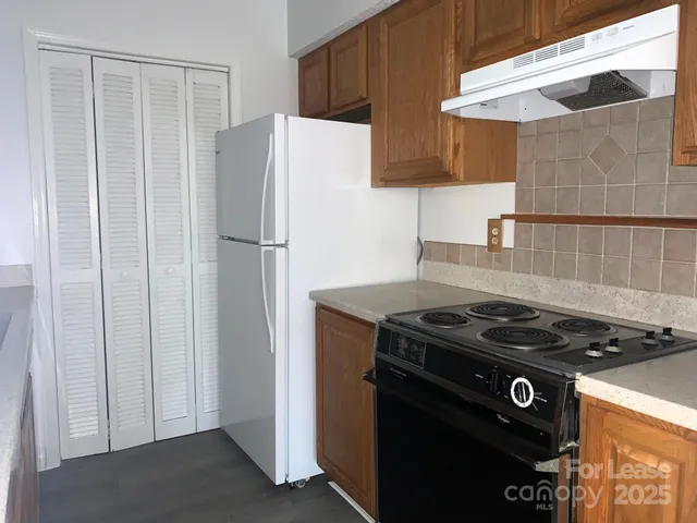 a kitchen with a stove and a refrigerator