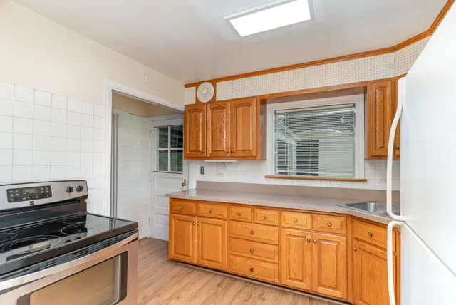 a kitchen with wooden cabinets and a stove top oven